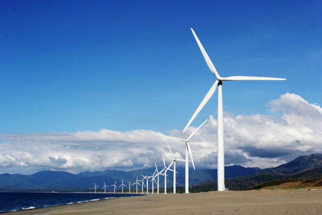 white-wind-turbines-on-gray-sand-near-body-of-water-3976320-1-scaled-1024x1024